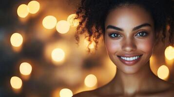 A person with beautiful curly hair showcases a bright smile, surrounded by a warm ambiance created by soft, glowing lights. This tranquil setting invites relaxation and self-care. photo
