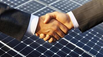 Two professionals shake hands on a solar panel installation site, symbolizing a commitment to sustainable finance and the promotion of renewable energy solutions for future development. photo
