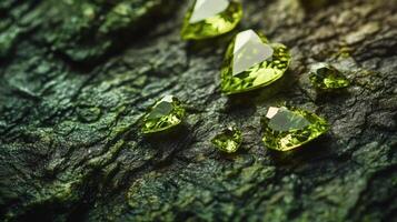 Beautiful green gemstones glimmer in various shapes, resting on a textured natural surface. The play of light highlights their clarity and color, creating an elegant display in a serene setting. photo