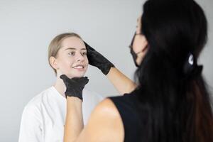 In a calming salon environment, a beauty expert applies permanent makeup to a client, enhancing her features while ensuring a comfortable and enjoyable experience. photo