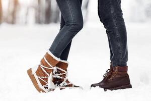 Romance. Unrecognizable Couple Standing In Snow On Winter Forest Background, Cropped, Copy Space photo
