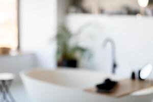 A spacious and bright modern bathroom showcases a freestanding tub, a stylish sink, and plants providing a touch of nature. The atmosphere is serene, perfect for relaxation. photo