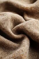 Close-up of textured brown burlap fabric with detailed weave pattern photo