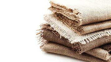 Stacked natural burlap fabric in various shades of brown and beige photo