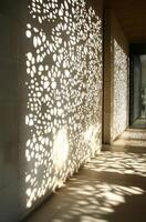 Sunlight patterns on architectural feature creating intricate shadows photo
