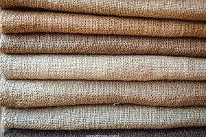 Stacked layers of natural burlap textiles in earthy tones photo