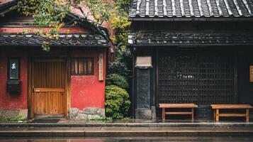 Traditional japanese street scene with red and black wooden buildings and lush greenery photo