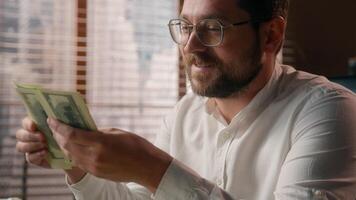 Joyful Caucasian businessman guy trader executive boss counting money savings banknotes in office worker smile accountant male calculate company profit business man dollars cash wages salary earnings photo