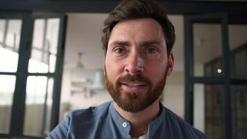 POV webcam smiling positive Caucasian man parent touching mobile phone screen happy male father dad surfing Internet web online at home guy using app swiping display smartphone device touchscreen view video