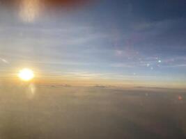 Golden sunrise over clouds aerial view nature photography serene landscape tranquil atmosphere inspirational moment photo