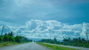 Scenic road trip view open highway beautiful clouds tropical landscape wide angle nature's artistry photo