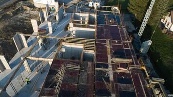 An aerial view captured by a drone showcasing the ongoing construction of a modern building, highlighting the work on the structure, scaffolding, and machinery on site photo