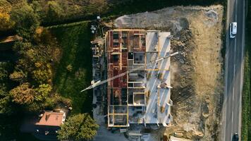 An aerial view captured by a drone showcasing the ongoing construction of a modern building, highlighting the work on the structure, scaffolding, and machinery on site photo