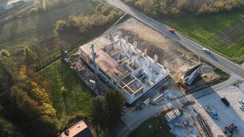 An aerial view captured by a drone showcasing the ongoing construction of a modern building, highlighting the work on the structure, scaffolding, and machinery on site photo
