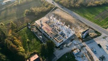An aerial view captured by a drone showcasing the ongoing construction of a modern building, highlighting the work on the structure, scaffolding, and machinery on site photo