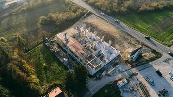 An aerial view captured by a drone showcasing the ongoing construction of a modern building, highlighting the work on the structure, scaffolding, and machinery on site photo