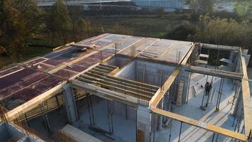 An aerial view captured by a drone showcasing the ongoing construction of a modern building, highlighting the work on the structure, scaffolding, and machinery on site photo