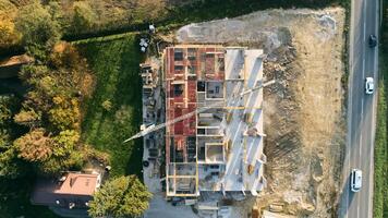 An aerial view captured by a drone showcasing the ongoing construction of a modern building, highlighting the work on the structure, scaffolding, and machinery on site photo