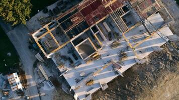 An aerial view captured by a drone showcasing the ongoing construction of a modern building, highlighting the work on the structure, scaffolding, and machinery on site photo