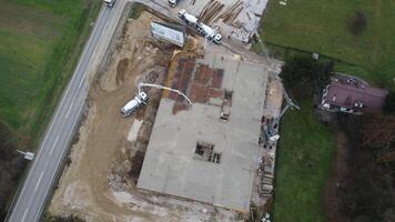 An aerial view captured by a drone showcasing the ongoing construction of a modern building, highlighting the work on the structure, scaffolding, and machinery on site photo