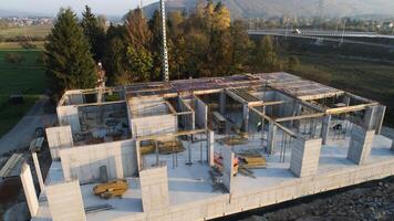 An aerial view captured by a drone showcasing the ongoing construction of a modern building, highlighting the work on the structure, scaffolding, and machinery on site photo