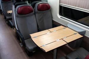 Empty seats and a table in a passenger carriage photo