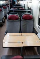 Empty seats and a table in a passenger carriage photo
