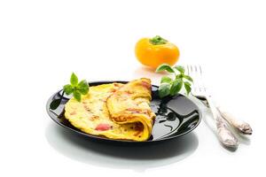 fried omelette with sweet pepper and vegetables in a plate, isolated on white background photo