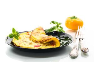 fried omelette with sweet pepper and vegetables in a plate, isolated on white background photo