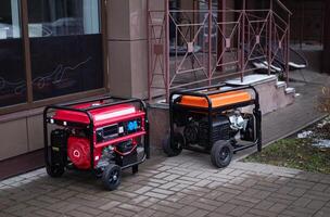 Two portable generators placed outside a building, showcasing power solutions for outdoor and emergency use photo