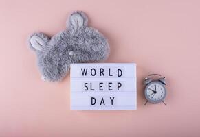 World sleep day message with alarm and plush toy photo