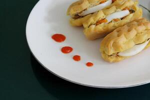 Fried Pastel with Egg Filling and Red Chili Garnish Close Up View on Plate Indonesian Snack Asian Cuisine photo