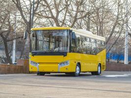 Yellow bus for transporting passengers and schoolchildren photo