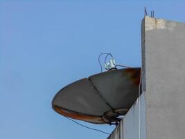 A satellite dish on top of a building photo
