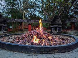 A fire pit in a circle with a stone wall photo