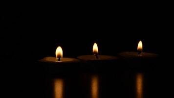 Candles shining with dark background with customizable space to add into the candles short clips video