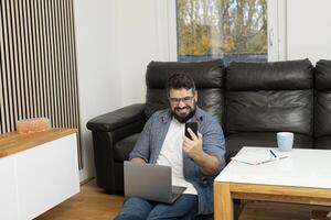 Angry stressed man having a phone call with a burnout face expression while working at the home office. photo