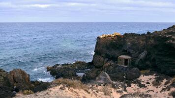 Beautiful coastal landscape scenery, fisherman's hut on the cliffs at Charco del Palo, Lanzerote, Canary islands, nature background photo