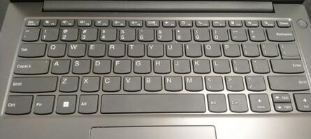 Details of the laptop keyboard photographed from various angles, showing a modern design with an ergonomic key layout photo