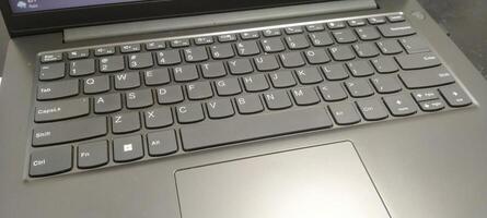 Details of the laptop keyboard photographed from various angles, showing a modern design with an ergonomic key layout photo
