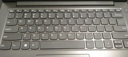 Details of the laptop keyboard photographed from various angles, showing a modern design with an ergonomic key layout photo