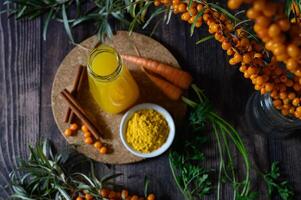 This image features a selection of ingredients for a refreshing and healthy drink, including sea buckthorn berries, lemon slices photo