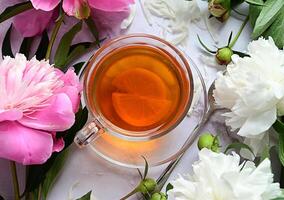 Bouquet of white piones. wiht a cap of tea. Cookies for breakfast. photo