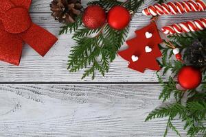 A Christmas card featuring toys, fir branches, and a garland, decorated with sweets and cinnamon. photo