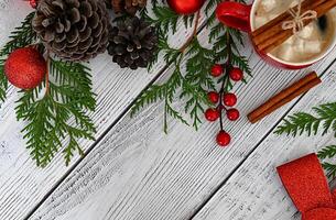 A joyful Christmas card embellished with playful toys, colorful fir branches, and a beautiful garland, accented with delicious treats and fragrant cinnamon. photo