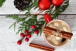 A delightful Christmas card adorned with charming toys, vibrant fir branches, and an exquisite garland, enhanced with scrumptious treats and aromatic cinnamon. photo