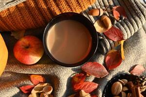 Autumn still life with a cup of coffee, autumn leaves,pumpkin . photo