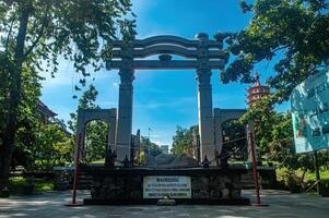 The serene Watu Gong Pagoda gate, surrounded by greenery and a clear sky, captures tranquility and heritage, often linked to Lunar or Chinese New Year. Indonesia, 17 November 2024 photo