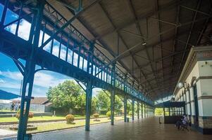 A historic train station with intricate ironwork and a spacious platform, showcasing a blend of architectural beauty and cultural heritage, Indonesia, 17 November 2024 photo