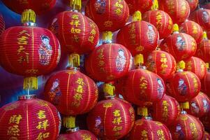 Red lanterns with Chinese characters and illustrations of children, symbolizing Lunar New Year celebrations. Indonesia, 17 November 2024 photo